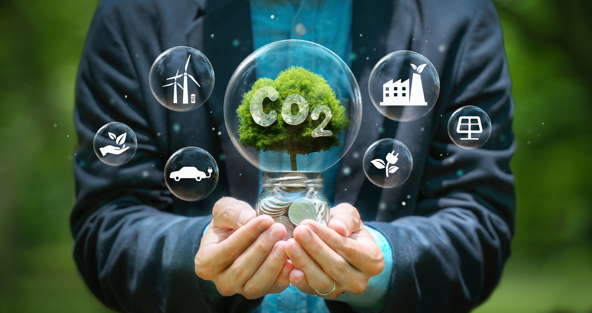 Conceptual image of a person holding a lightbulb with a green tree inside, symbolizing eco-friendly energy, surrounded by bubbles containing icons for wind power, electric vehicle, sustainable industry, and solar panels, representing the integration of carbon management and renewable energy solutions